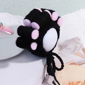 Detail of funny pet costume featuring black knit wig with pink sponge hair rollers