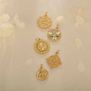 Retro gold-plated round tarot pendants set with cubic zirconia on beige silk fabric