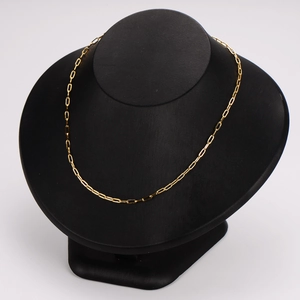 Minimalist gold square wire long cross chain necklace displayed on a black stand