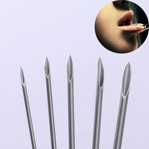 Close-up view of five stainless steel hollow body piercing needles for professional use