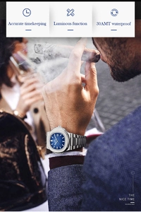 Close-up of luxury thin quartz watch with blue dial on wrist featuring luminous markers