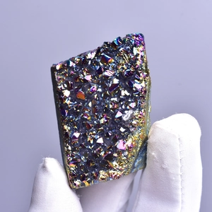 Handheld vibrant rainbow aura quartz crystal cluster with metallic luster and mineral points