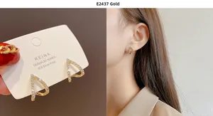 Close-up of gold triangle earrings with S925 silver needles and sparkling zircon stones