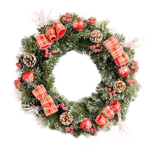 Classic snowy Christmas wreath with red bows, pine cones, and berries on white background