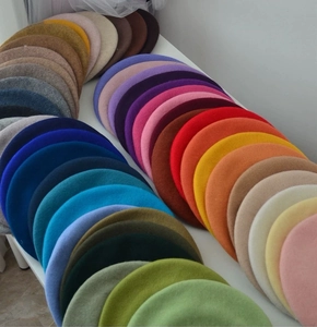 Macro shot showing rich color palette and soft wool texture of various beret hats