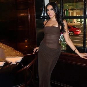 Detailed view of brown sheer mesh fabric and ruched textures on backless halter maxi dress