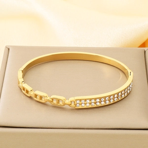 Macro shot of gold pig nose link bracelet with double rows of sparkling rhinestones
