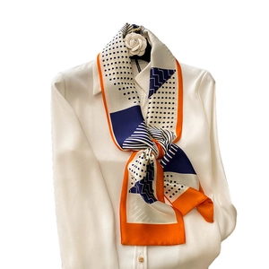 Elegant polka dot striped silk necktie scarf knotted on white shirt for women