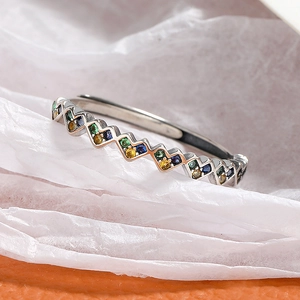Macro detail of S925 sterling silver ring featuring colorful zircon stones in a wave pattern