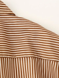 Detail of brown and white striped tencel shirt dress showing shoulder seam and fabric texture
