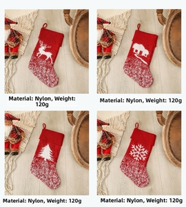 Detail of four festive knitted Christmas stockings with reindeer and tree patterns