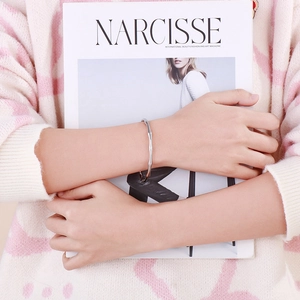 Minimalist silver stainless steel bamboo open bangle worn on a model with a lifestyle vibe