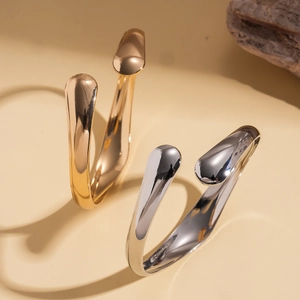 Minimalist geometric open cuff bracelets in polished gold and silver finishes