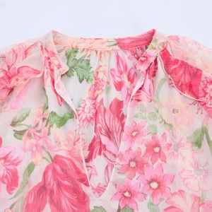 Women's pink floral chiffon blouse featuring a deep V-neck and layered light fabric