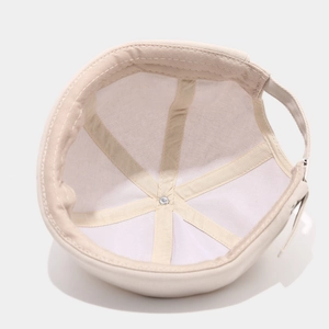 Interior view of beige cotton docker hat showing six-panel stitch and adjustable strap