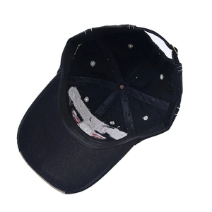 Detail showing inner cotton construction and adjustable metal buckle of the black baseball cap