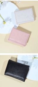 Detailed view of cute cartoon animal embossed patterns on colorful PU leather wallets