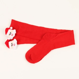 Detail of red striped Christmas socks with a 3D Santa Claus plush toy ornament