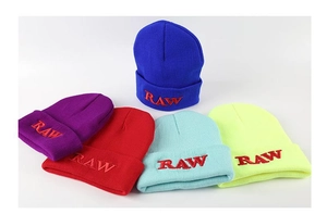 Detailed view of colorful knit beanies with RAW embroidery in street fashion style