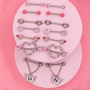 Detail showing 14 pieces of pink heart and rose nipple rings on round displays