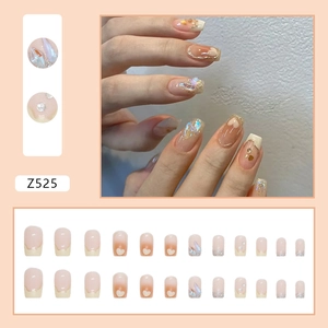 Sparkly nude pink French press-on nails with glitter, aurora foil, and heart design