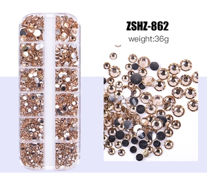 Detail view of champagne gold flatback rhinestones in a 12-slot storage box