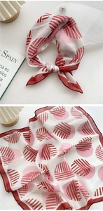 Detail showing red geometric stripe pattern and delicate hem on cotton linen neck scarf