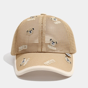 Close-up of breathable mesh fabric and cute bear embroidery on a child's sun cap