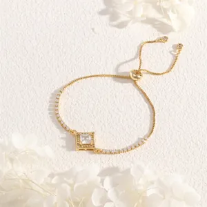 Detail of adjustable gold-plated tennis bracelet with central square zircon stone