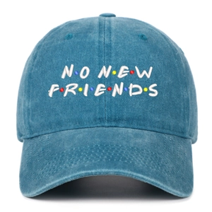 Close-up of white NO NEW FRIENDS embroidery on a washed blue denim baseball cap