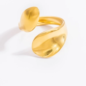 Macro detail of golden irregular flowing ring with polished finish and organic texture