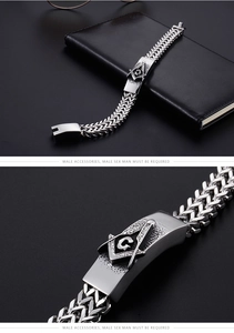 Macro detail of antique silver Freemasonry emblem on a stainless steel braided bracelet