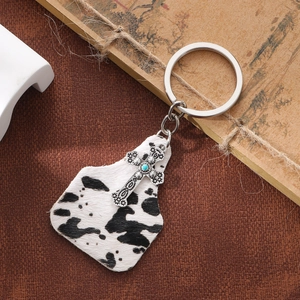 Vintage western keychain with cow print fur, silver cross pendant and blue bead