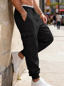 Detail of men's black cargo joggers showing side flap pockets and fleece texture