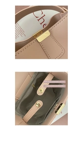 Detail view of pink bucket bag showing golden clasp and internal storage compartments