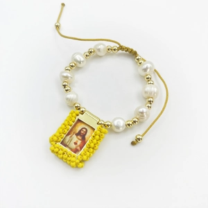 Detail view of handmade natural pearl bracelet with Sacred Heart of Jesus icon