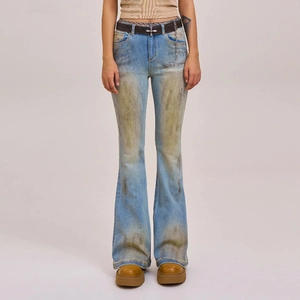 Close-up of vintage washed flare jeans with distressed blue finish and waist chain detail