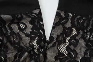 Detailed macro view of high-quality black floral lace fabric with hidden zipper closure