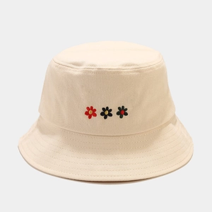 Close-up of small flower embroidery details on cream cotton bucket hat for women