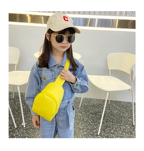 Detail shot of a vibrant yellow toddler PU leather crossbody bag worn by a child model
