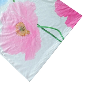 Detailed close-up showing vibrant pink flower print and fine double-stitching on white fabric