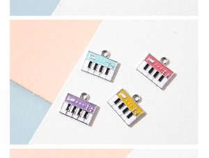 Detailed view of colorful piano keyboard pendants in mint green, red, purple, and yellow