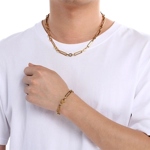 Golden handmade rectangular link chain necklace and bracelet set worn by a model