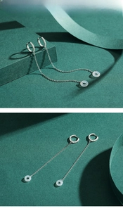Detail view of long S925 sterling silver chain earrings with white jade and zircons