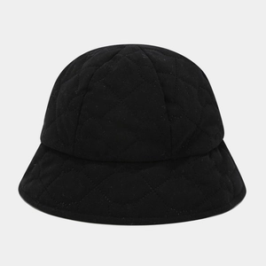 Close-up of black quilted bucket hat with classic diamond pattern stitching and soft texture