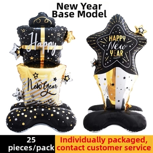 Detail of Happy New Year star and gift box foil balloons on stand for party decor