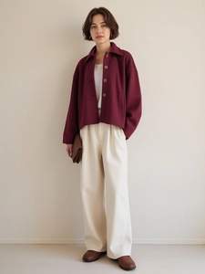 Detail of the burgundy wool jacket showing lapels, buttons, and high-quality fabric texture