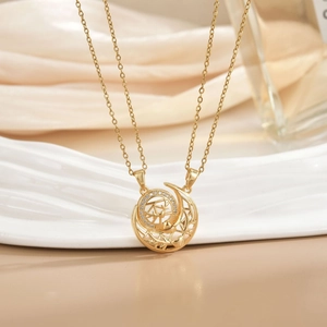 Detail of gold necklace with crescent moon and disc pendant featuring micro-pave zircons