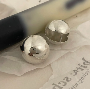 Macro detail of S925 sterling silver stamp on polished spherical stud earring