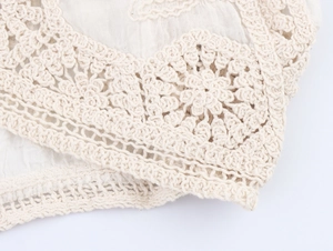 Detailed macro view of crochet knit pattern with floral lace textures and hollow design